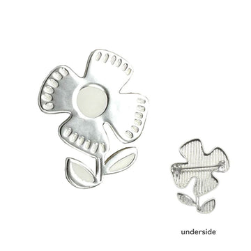 A silver brooch in the shape of a flower with a second brooch showing the pin on the underside.