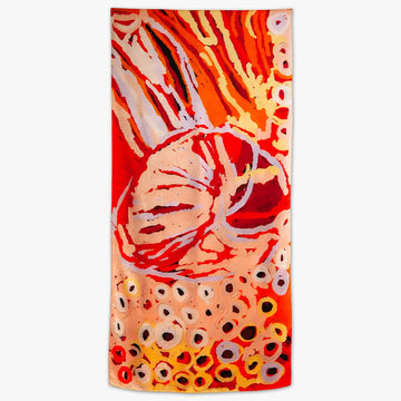 A silk scarf laying flat and printed with artowrk in shades of orange by Katarra Butler Napaltjarri.