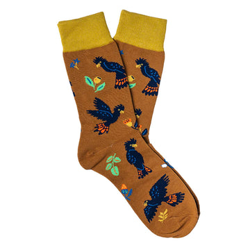 A pair of brown socks illustrated with black cockatoos.