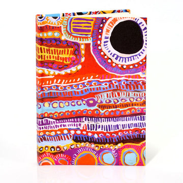 A hardcover notebook printed with colourful Indigenous artwork.