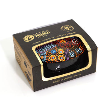 A small trinket dish inside a box with a cut out.