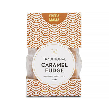An orange and white patterned box with the heading 'Traditional Caramel Fudge' in the middle and a window on the sides showing the caramel fudge inside.