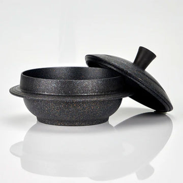 Black speckled cauldron pot with lid on a white background.