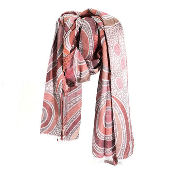 A scarf printed with an Indigenous design in shades of red and brown.