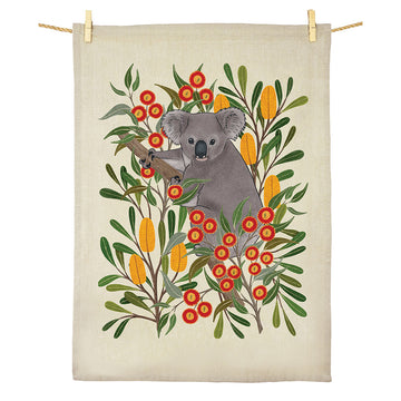 A cotton tea towel illustrated with a koala in a gum tree.