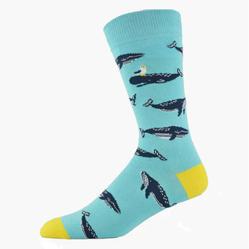 A blue sock with a yellow heel and toe and illustrated with whales.