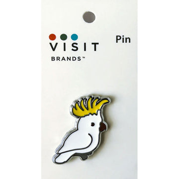 Bird-shaped pin on a white card with 'Visit Brands' branding.