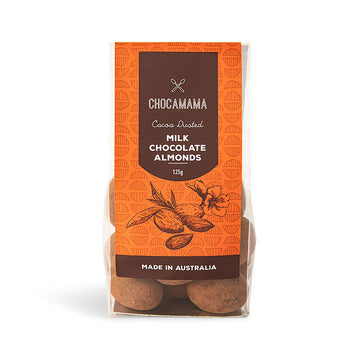 A clear bag with a large orange label with the heading 'Milk Chocolate Almonds'. The almonds can be seen inside the bag.