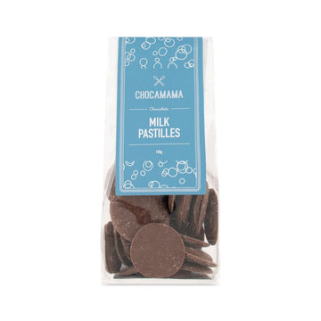 A clear bag with a large blue label with the heading 'Milk Pastilles'. The chocolates can be seen inside the bag.