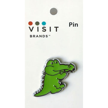 Green crocodile-shaped pin on a white card with 'Visit Brands' logo.