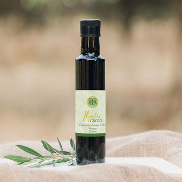 A bottle of apple cider vinegar on a linen cloth.