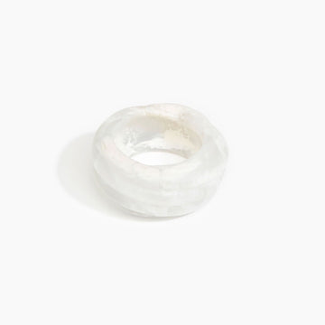 A resin bangle in white with a spiral shape.