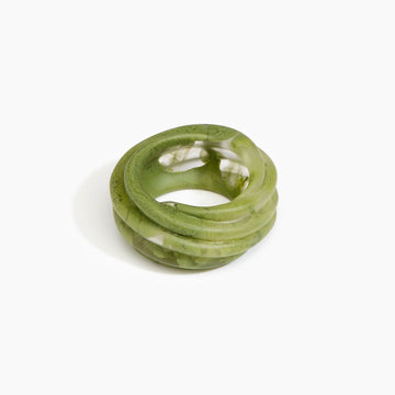 A resin bangle in olive green with a spiral shape.