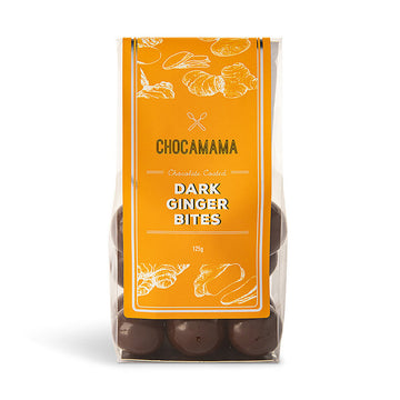 A clear bag filled with chocolate covered ginger with a large yellow product label and the text 'Chocomama Dark Ginger Bites'.