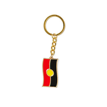 An enamel keyring in gold with the Aboriginal flag attached.