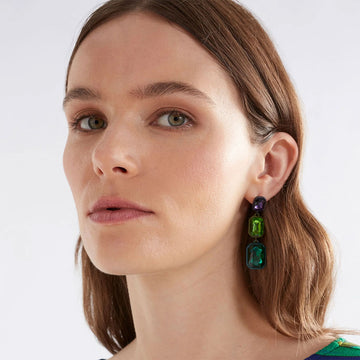 A pair of drop earrings featuring three rectangle gem stones in different sizes and shades of red.