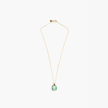 A gold necklace with a light moss green resin pendant.
