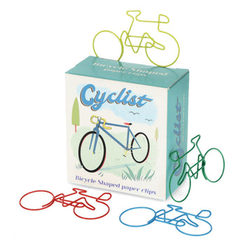 A box titled 'Cyclist Bicycle shaped paper clips' with an illustration of a bicycle on the front. There are four different coloured bicycle shaped paper clips around the box.