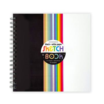 A sketchbook with black on one side and white on the other and coloured lines in the middle.