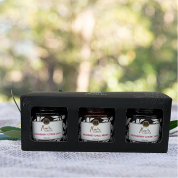 A black box with three jars inside and a cut out window in front of each jar.
