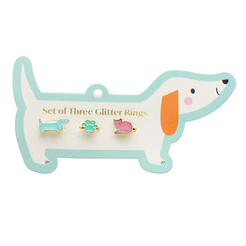 A sausage dog shaped card with the heading 'Set of Three Glitter Rings' with a dog shaped ring in blue glitter, a paw print shaped ring in green glitter and a cat shaped ring in pink glitter.