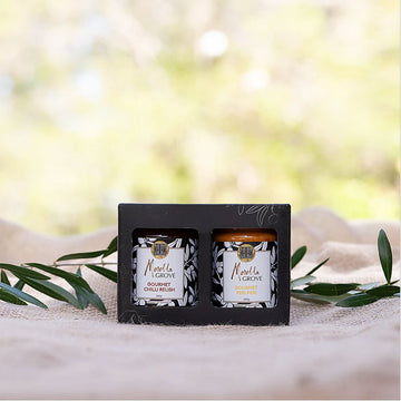 A black box with two cut outs showing jars of chilli relish and peri peri sauce inside.
