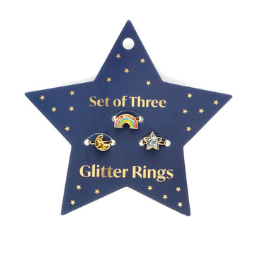 A star shaped backing card titled 'Set of Three Glitter Rings' with a rainbow shaped, a moon shaped and a star shaped ring each in a different glitter colour attached to the card.