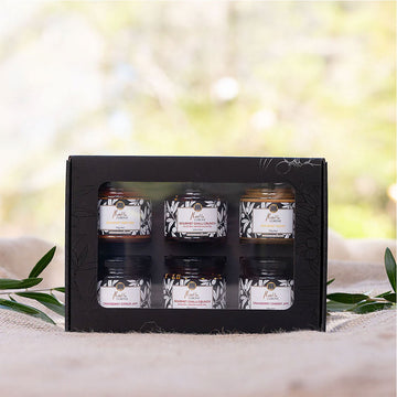 A black box with a clear window showing six jars inside.