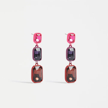 A pair of drop earrings featuring three rectangle gem stones in different sizes and shades of red.