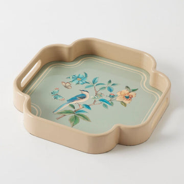 Decorative tray with floral and bird design on a light background.