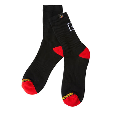A pair of black socks with a red heel and toe and outline of the Aboriginal flag on the back.