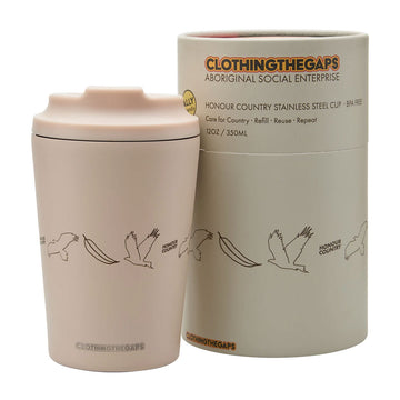 A stainless steel cup printed with birds and leaves next to its matching cylinder box.