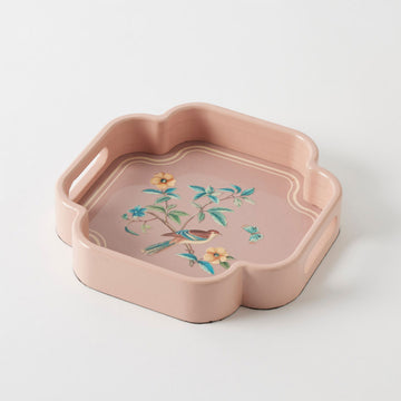 Pink decorative tray with floral and bird design on a white background.