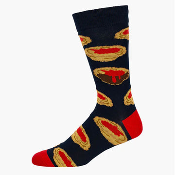 A black sock with a red heel and toe and illustrated with meat pies with sauce.