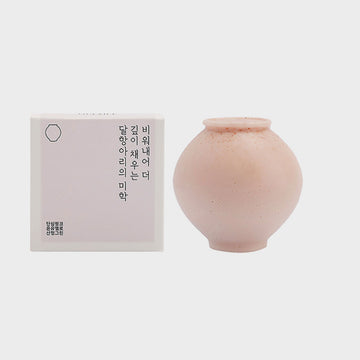 Pink soap shaped like a vase with packaging on a white background.