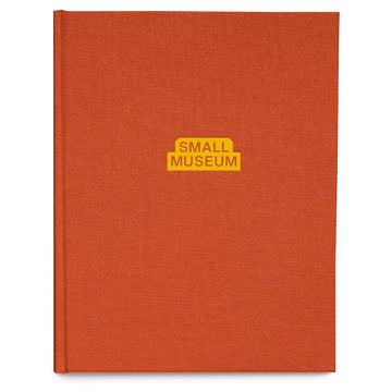 Orange book with 'Small Museum' label on a white background.