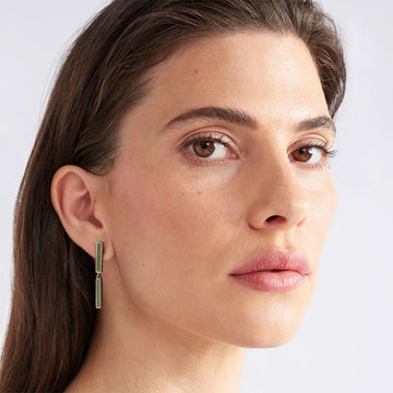 A pair of stud earrings featuring two thin pink bars linked together and bevelled in rose gold.