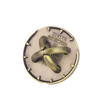 A metal puzzle inside a box titled 'Sun Compass'.