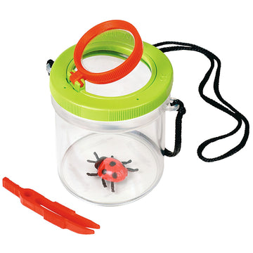 A clear plastic jar with a toy ladybug inside with tweezers and a magnifying glass.