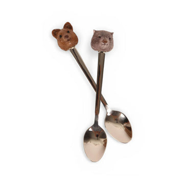 Two animal-themed spoons with decorative handles on a white background.