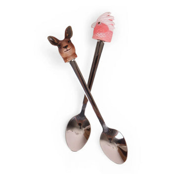 Two spoons with animal-shaped handles on a white background.