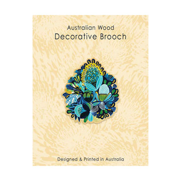 Decorative brooch with floral design on a textured beige background.