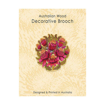 Decorative brooch with floral design on a textured beige card, labeled 'Australian Wood Decorative Brooch'.