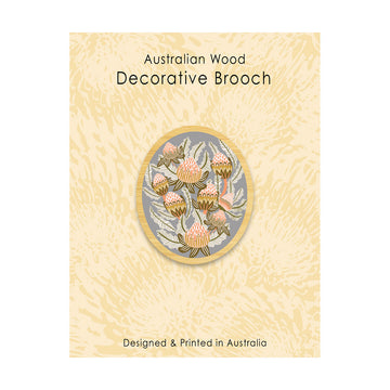 Decorative brooch with floral design on a beige card, labeled 'Australian Wood Decorative Brooch'.