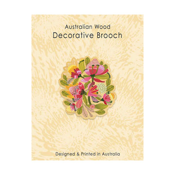 Decorative brooch with floral design on a textured beige background, labeled 'Australian Wood Decorative Brooch'.