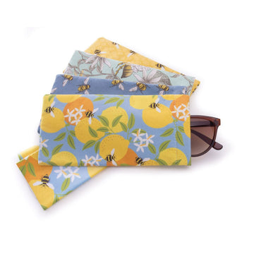 Four glasses cases stacked in a fan shape each with a different bee pattern on them. The top case has a pair of glasses poking out.