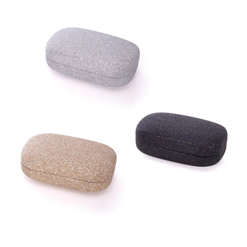 Three glitter covered travel cases in silver, black and gold.