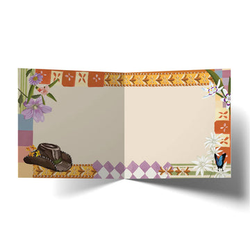Birthday card with a kookaburra, hat, and flowers on a colorful patterned background.