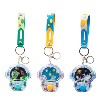Three space shaped water games attached to keyrings.