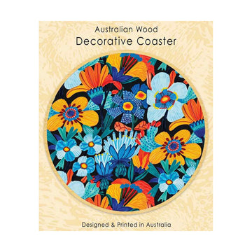 A wooden round coaster printed with blue flowers.